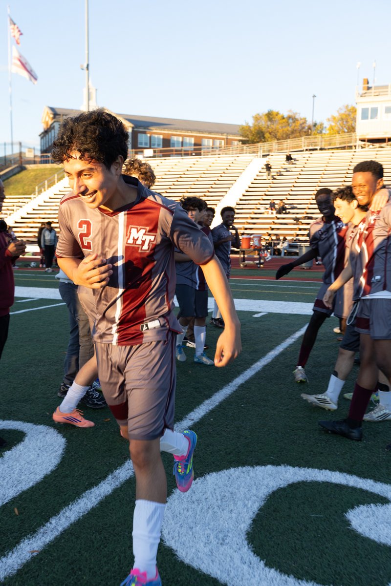 Soccer player on the field, stadium in the background